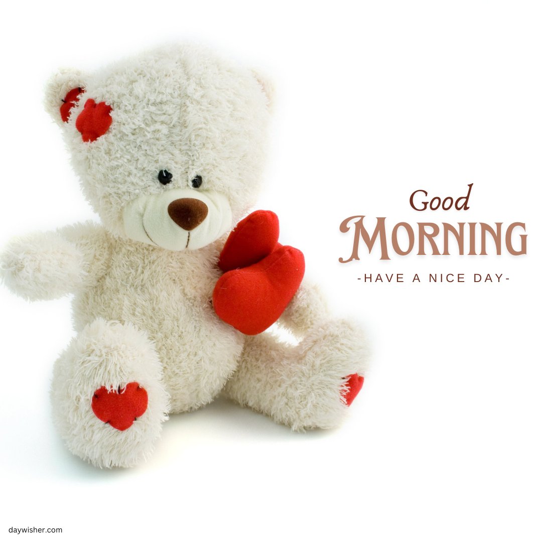 A cute good morning teddy bear holding a red heart, with small red hearts on its ears and feet. The image features the text "Good Morning - Have a Nice Day" in elegant letters.