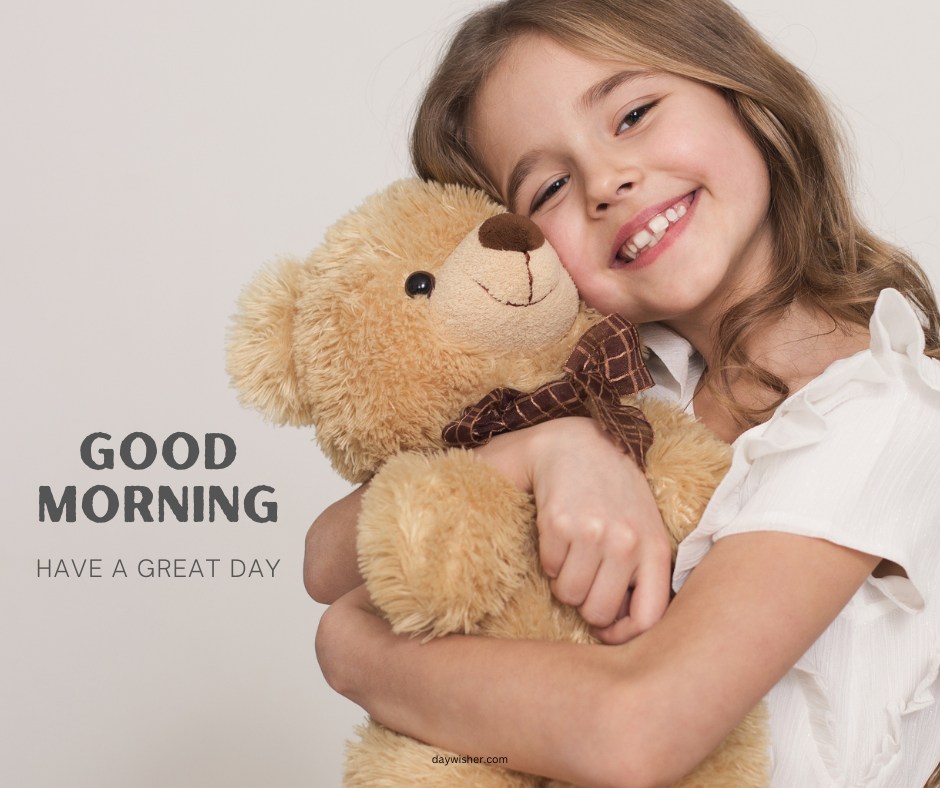 A smiling young girl hugging a large teddy bear, creating a warm and happy scene. The image features the text "Good Morning - Have a Great Day," conveying a cheerful and positive message.