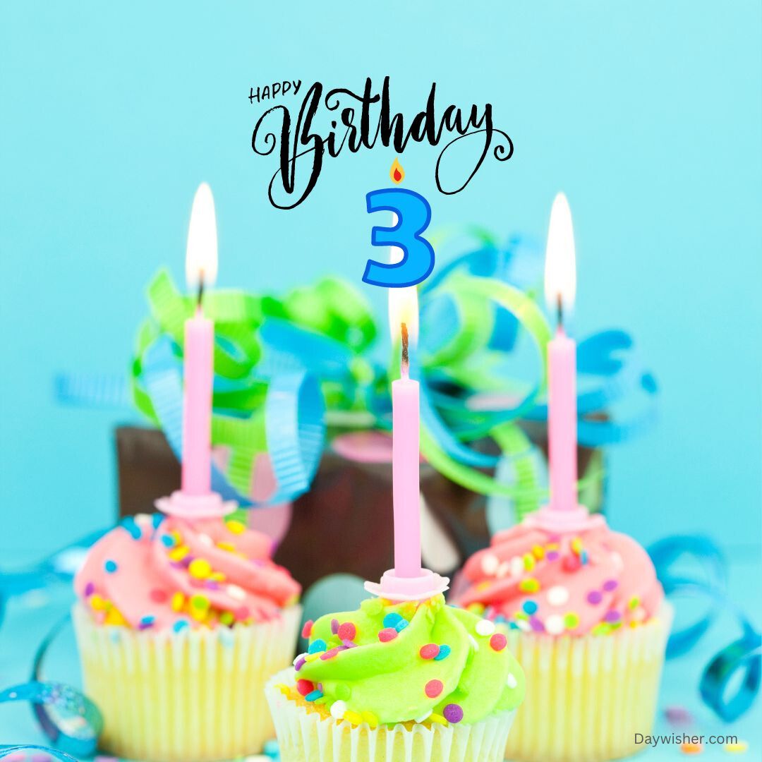 Three colorful cupcakes with pink and green frosting, decorated with sprinkles and topped with lit candles, celebrate a happy 3rd birthday against a blue background.