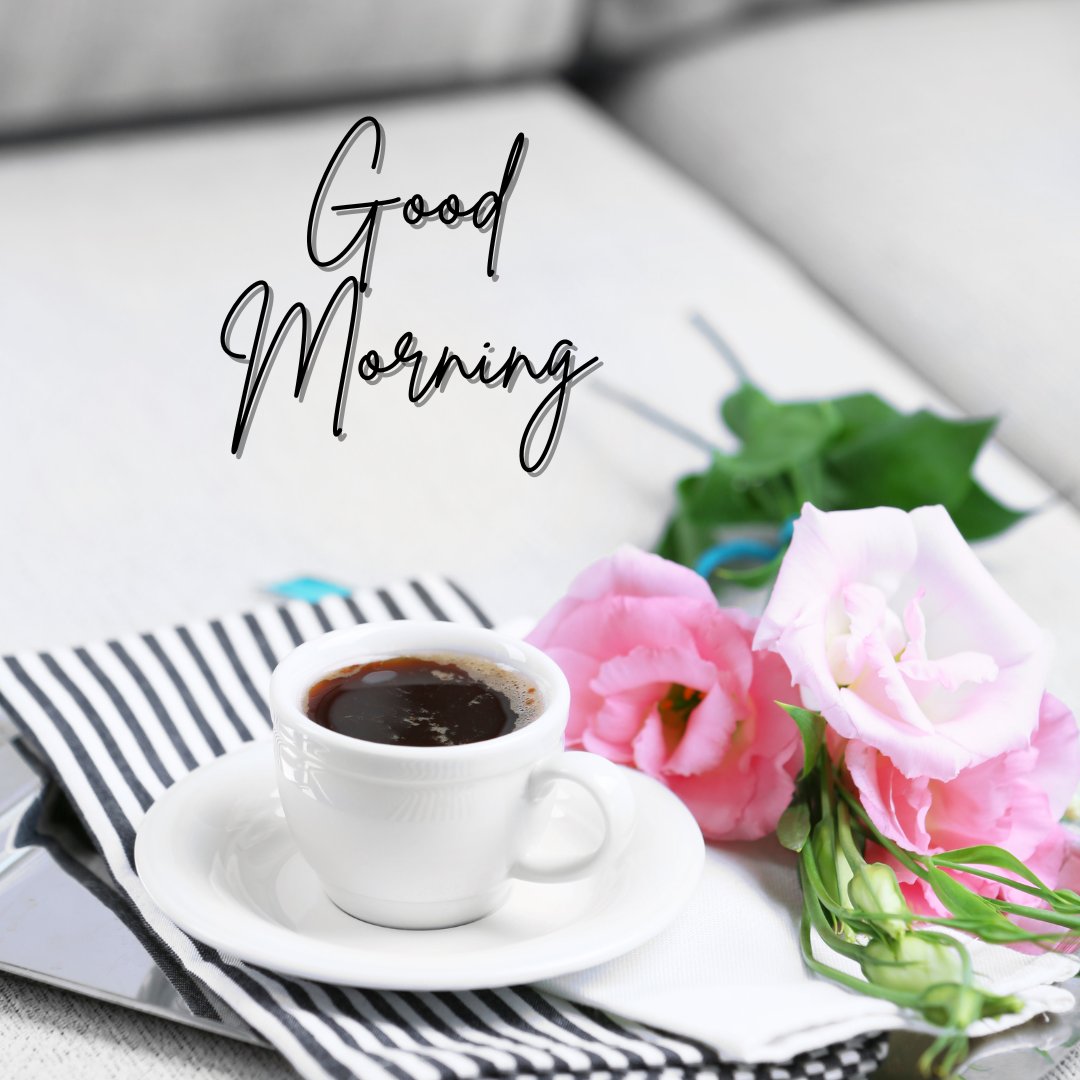 Chic good morning coffee image featuring a cup of espresso on a white saucer, accompanied by vibrant pink flowers on a striped black and white cloth, with a 'Good Morning' script floating above, offering a stylish morning refreshment.