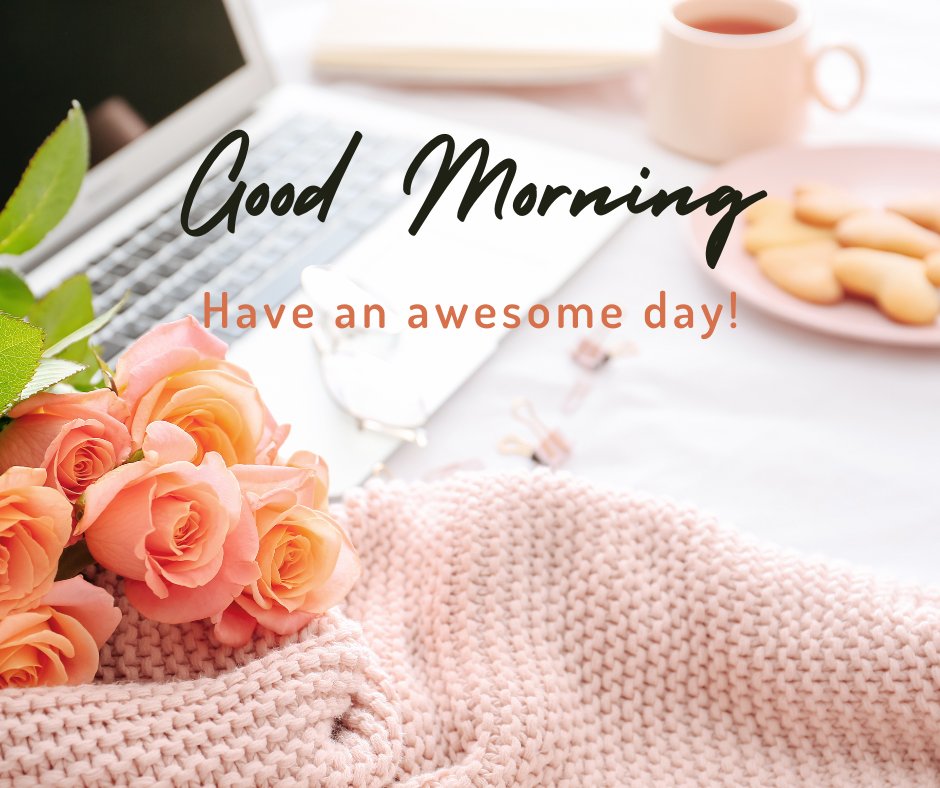 Inspiring good morning coffee image depicting a cozy workspace with a light pink mug, fresh orange roses, cookies, a soft knitted blanket, and a laptop, all under the greeting 'Good Morning, Have an awesome day!'